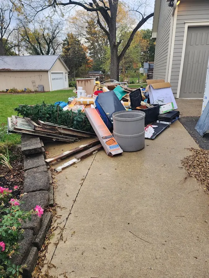Dumpster being loaded with debris for Estate Cleanout Dumpster Rental in Sandia Heights
